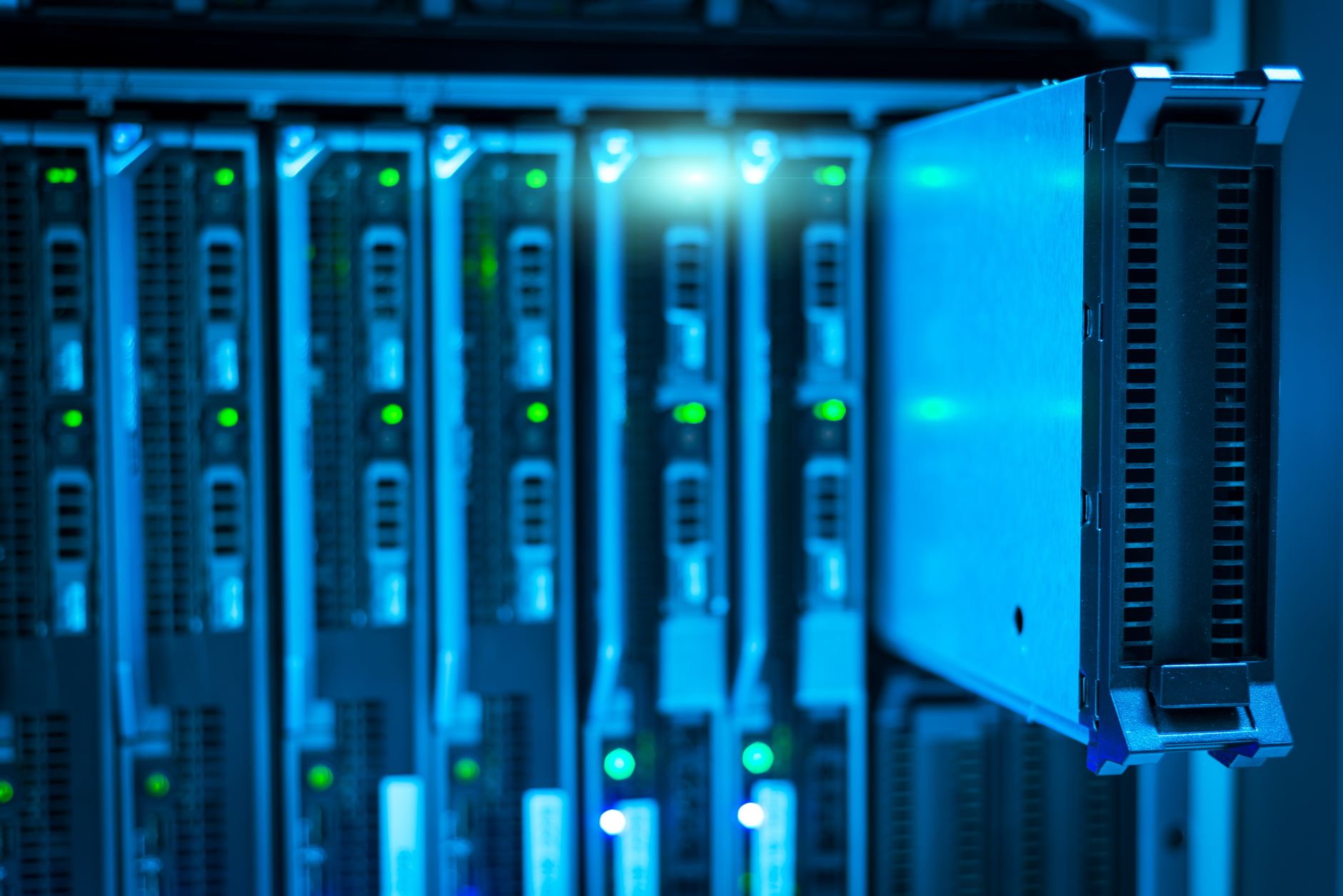 Bitcoin mining hardware in a data center with blue lighting