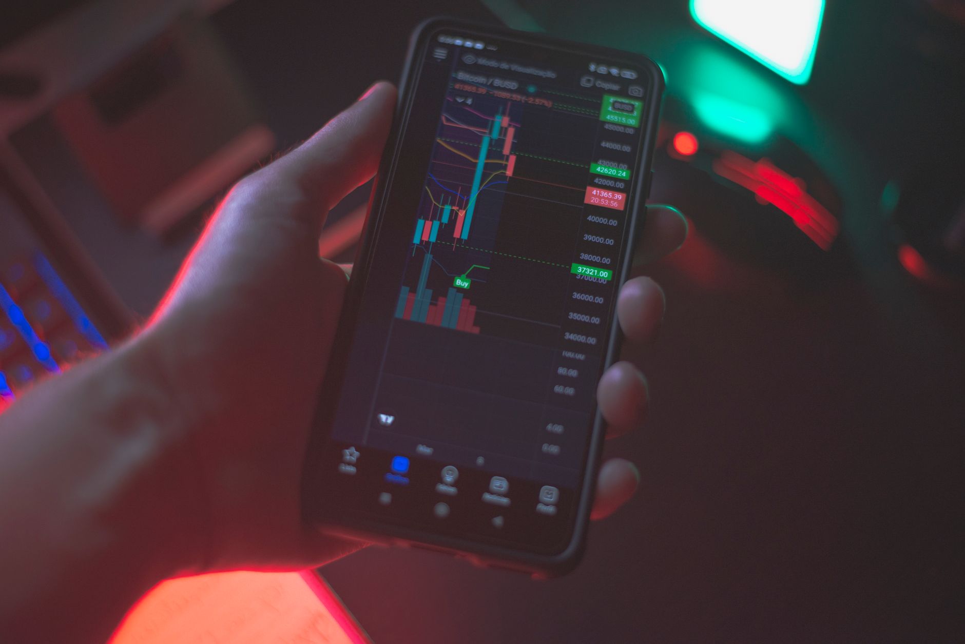 Person holding a smartphone with a cryptocurrency app open outdoors