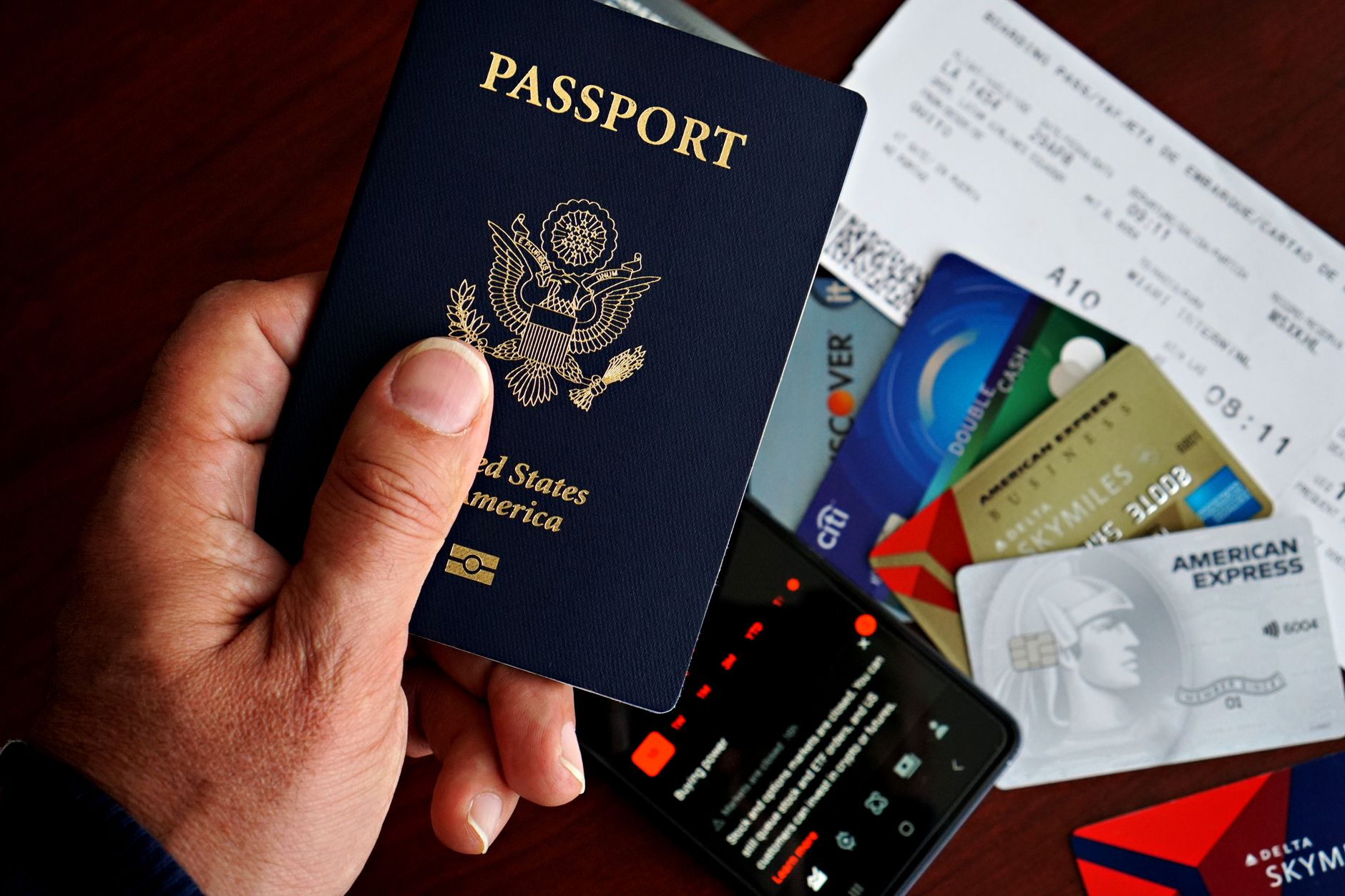 Person holding a passport for identity verification on a smartphone