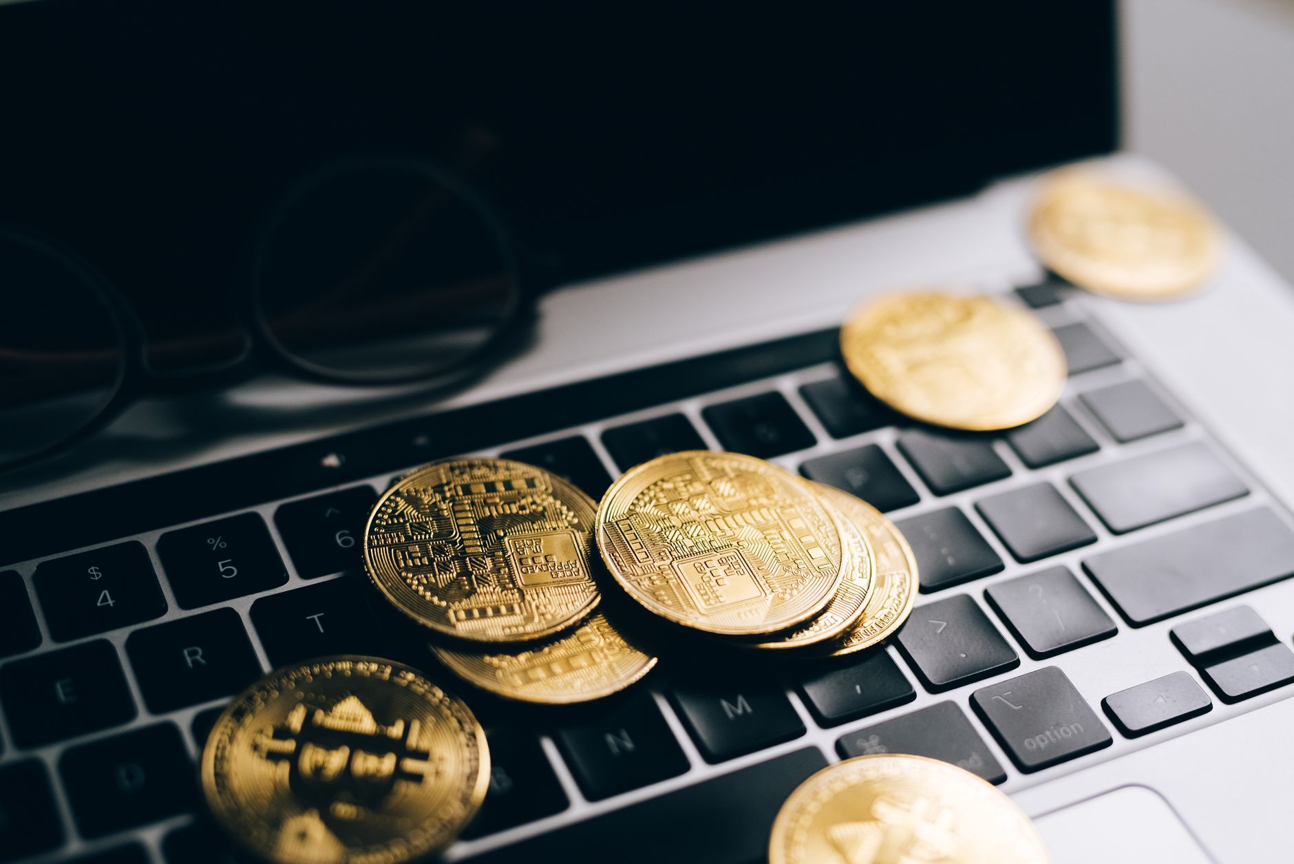 Laptop showing a crypto trading platform with charts